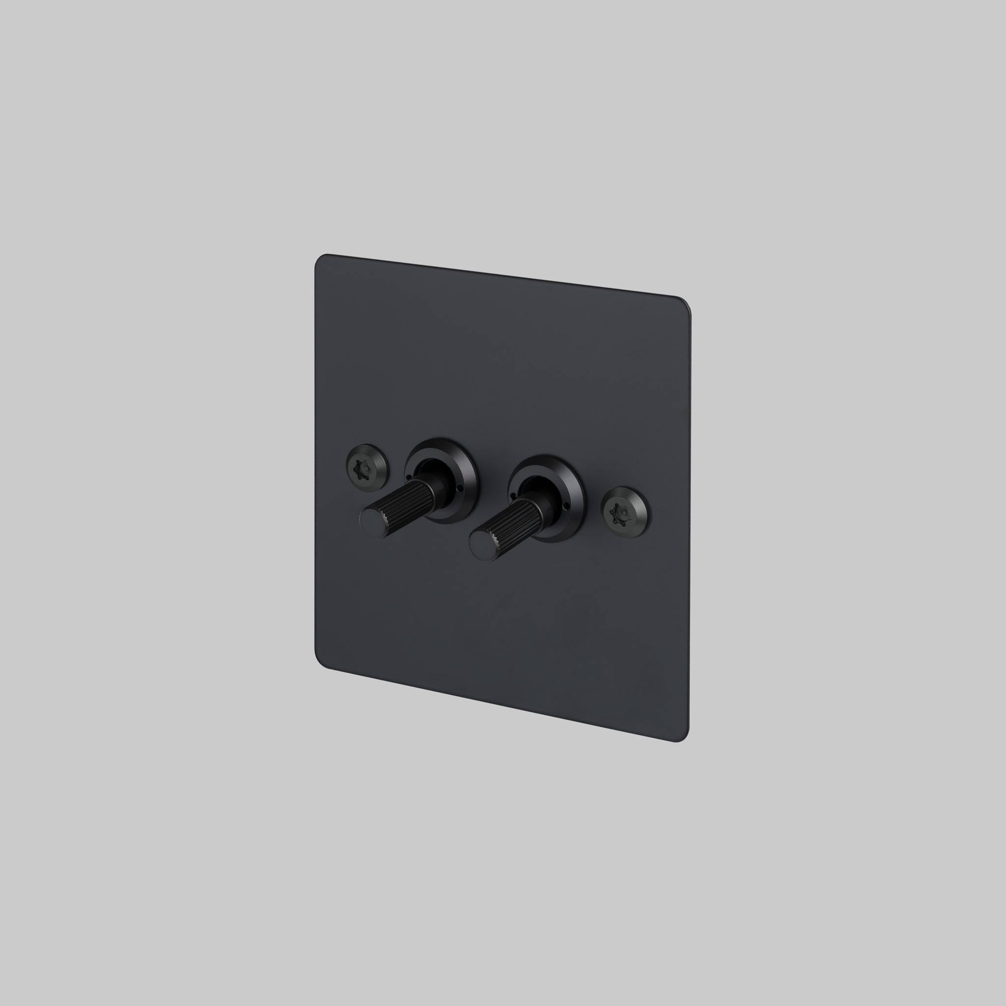 Buster + Punch 2G 2-way toggle switch, black plate with black linear knurl toggle arm, front view