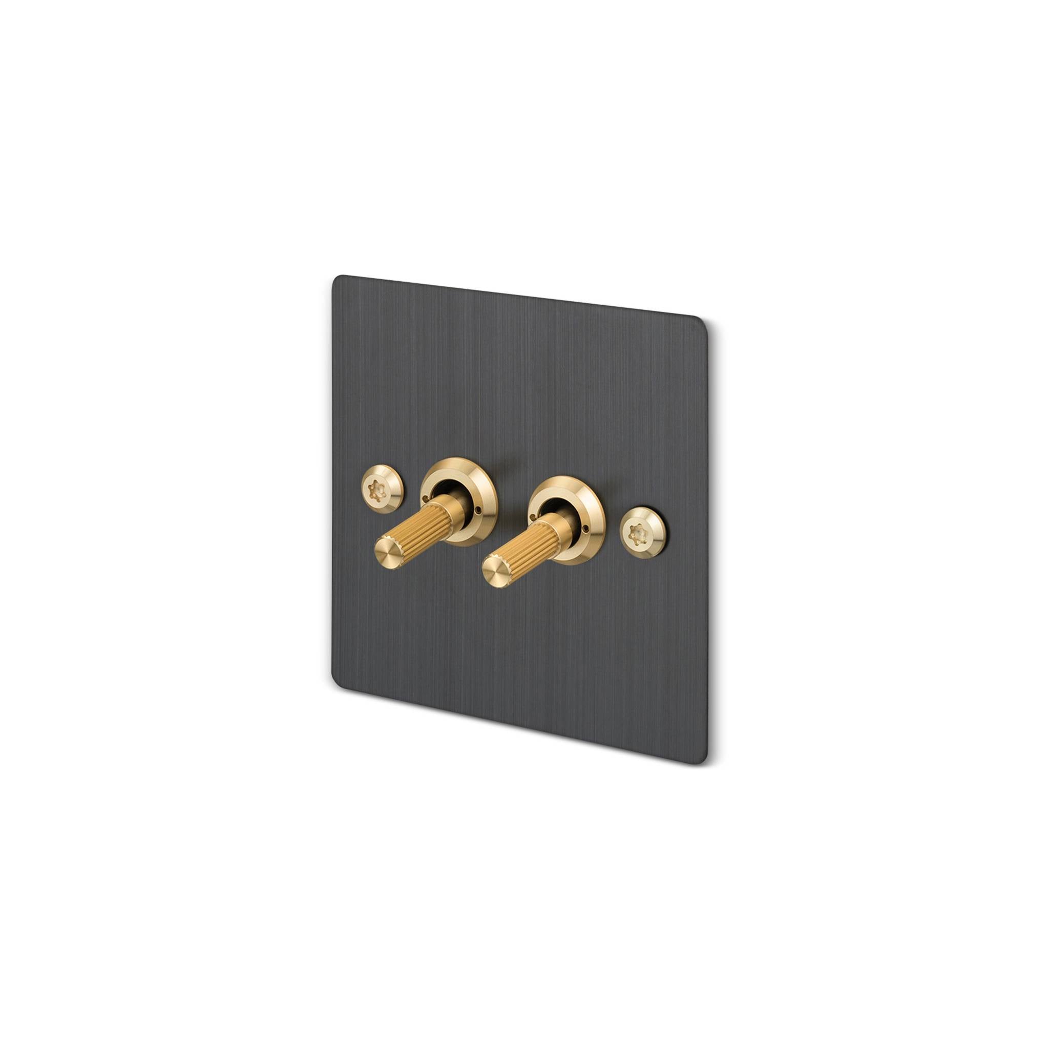 Buster + Punch 2G 2-way toggle switch, smoked bronze plate with brass linear knurl toggle arm, isolated cutout