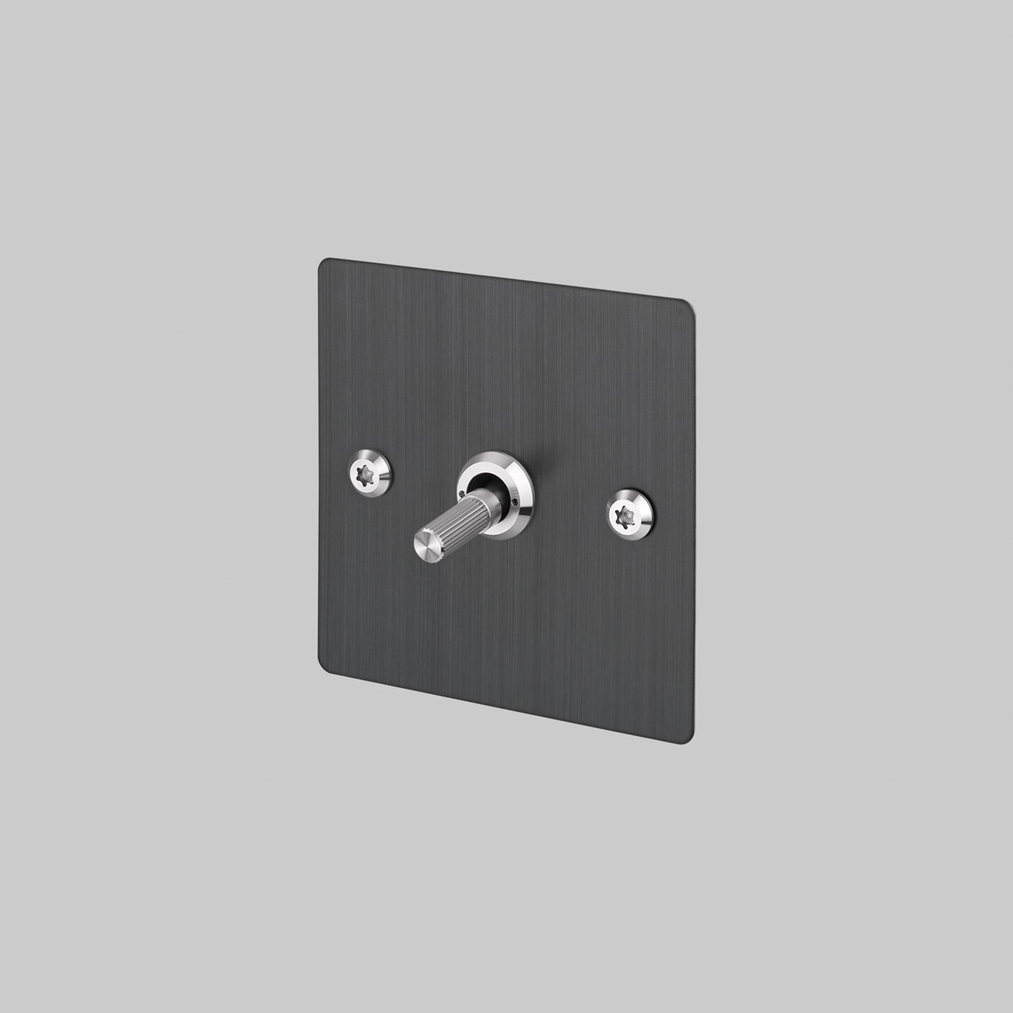 Buster + Punch 1G 2 way toggle switch, Smoked Bronze plate with Steel linear knurl toggle arm, elevated angle view