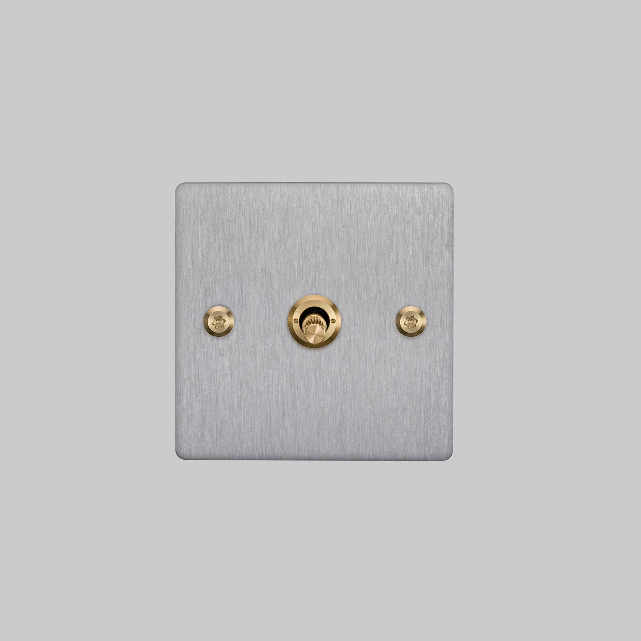 Buster + Punch 1G 2 way toggle switch, Steel plate with Brass linear knurl toggle arm, front view