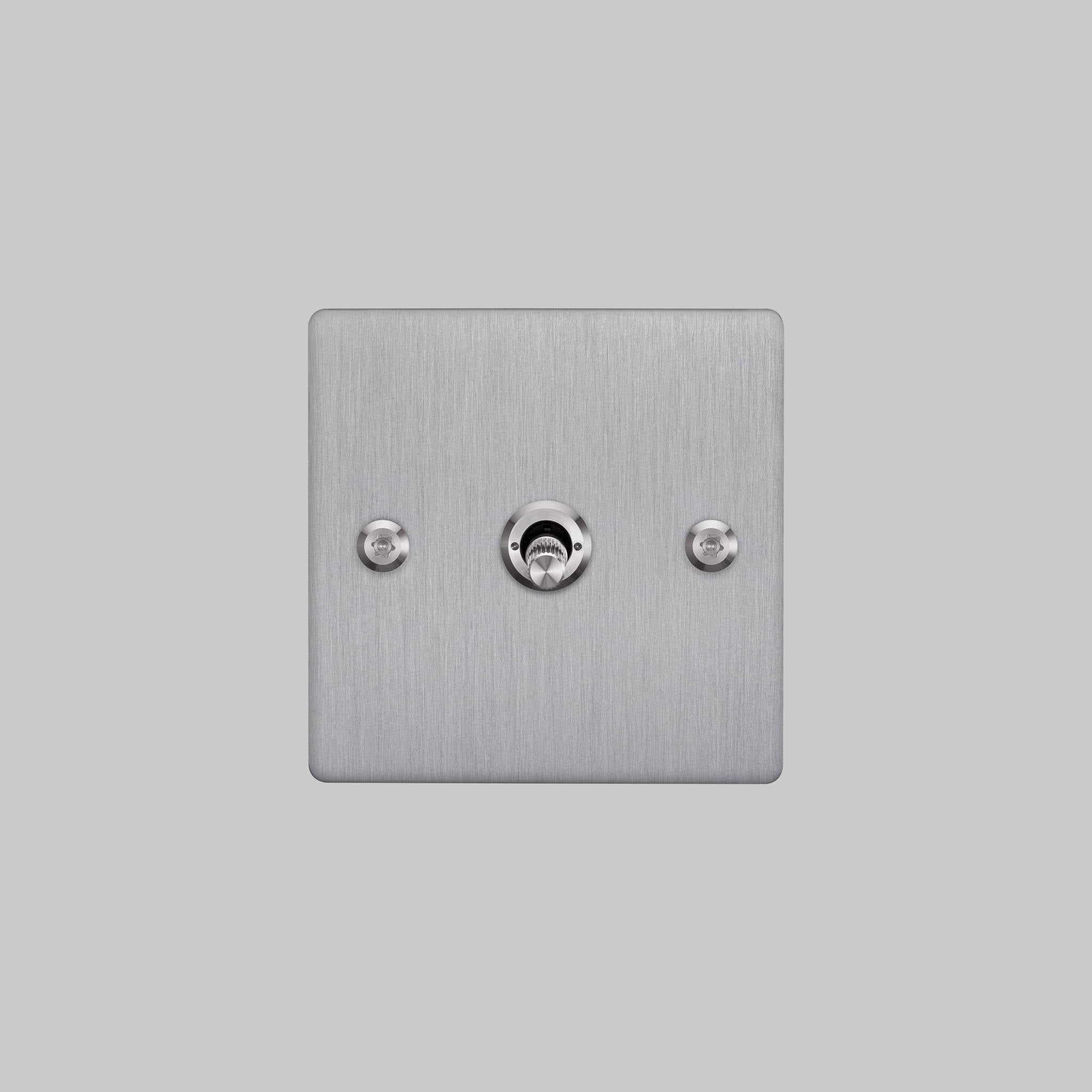 Buster + Punch 1G intermediate toggle switch, steel plate with steel linear knurl toggle arm, front elevation