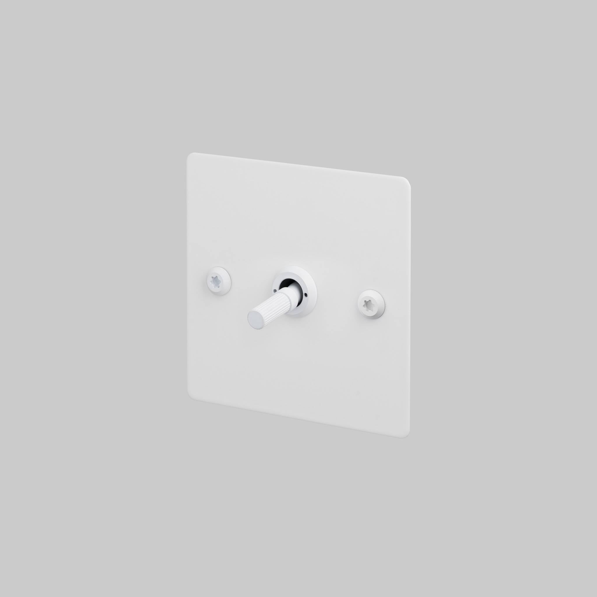 Buster + Punch 1G intermediate toggle switch, white plate with white linear knurl toggle arm, front view