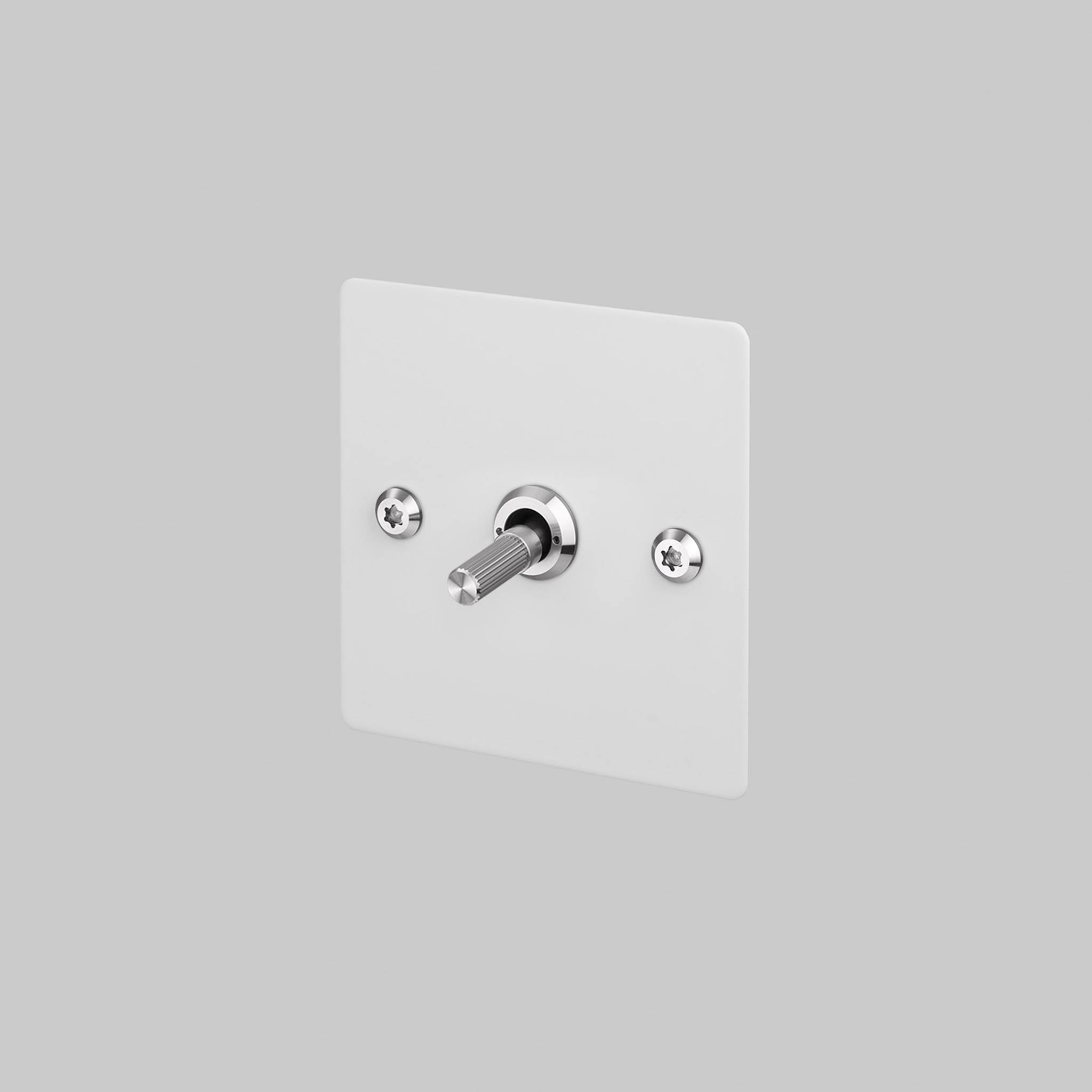 Buster + Punch 1G 2 way toggle switch, White plate with Steel linear knurl toggle arm, elevated angle view
