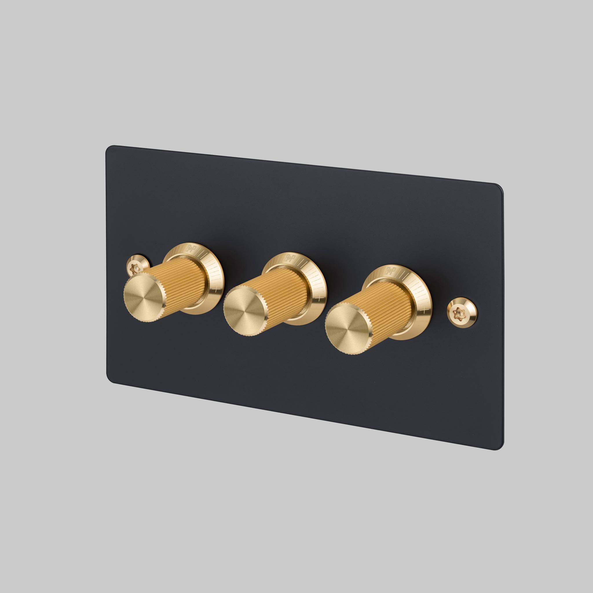 Buster + Punch 3G dimmer switch, black plate with brass linear knurl knobs, front view
