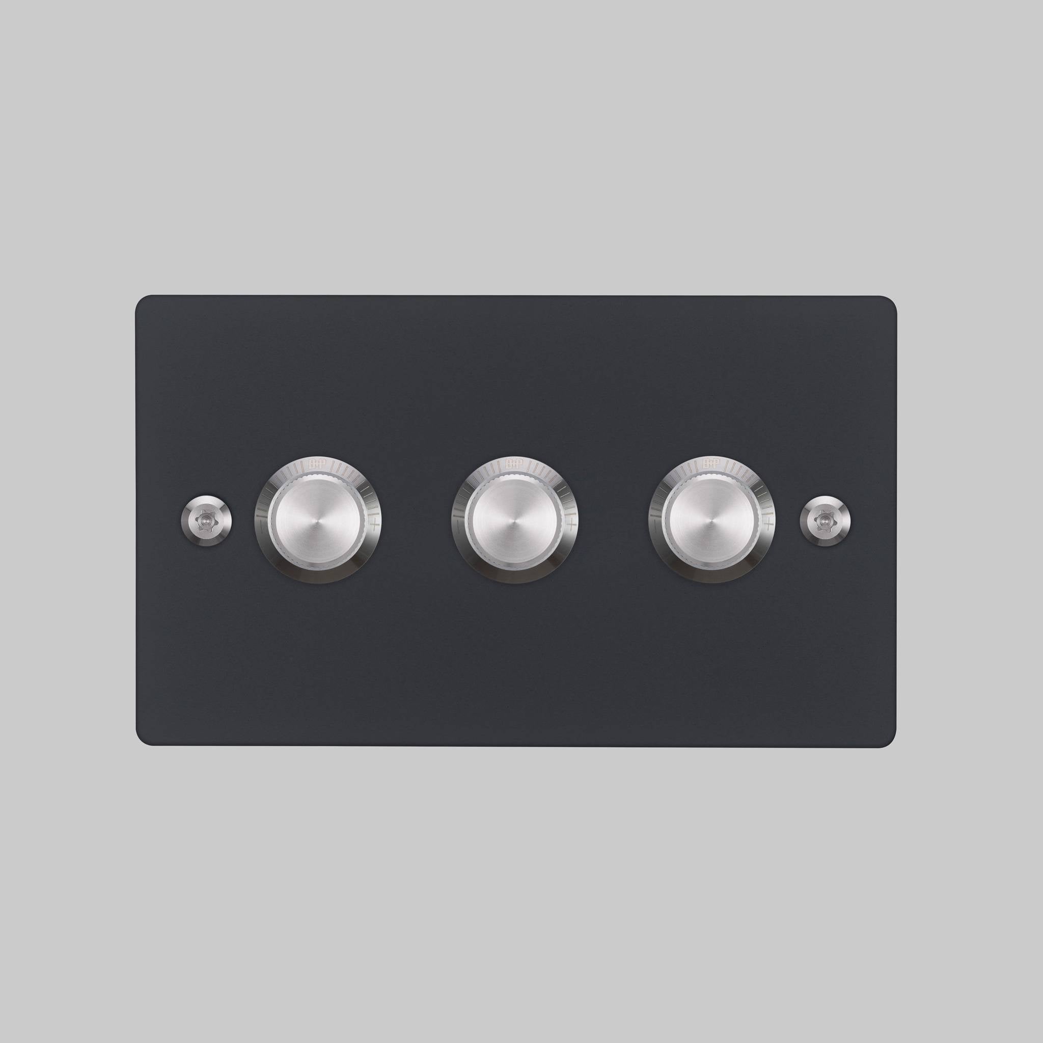 Buster + Punch 3G dimmer switch, black plate with steel linear knurl knobs, elevated angle view