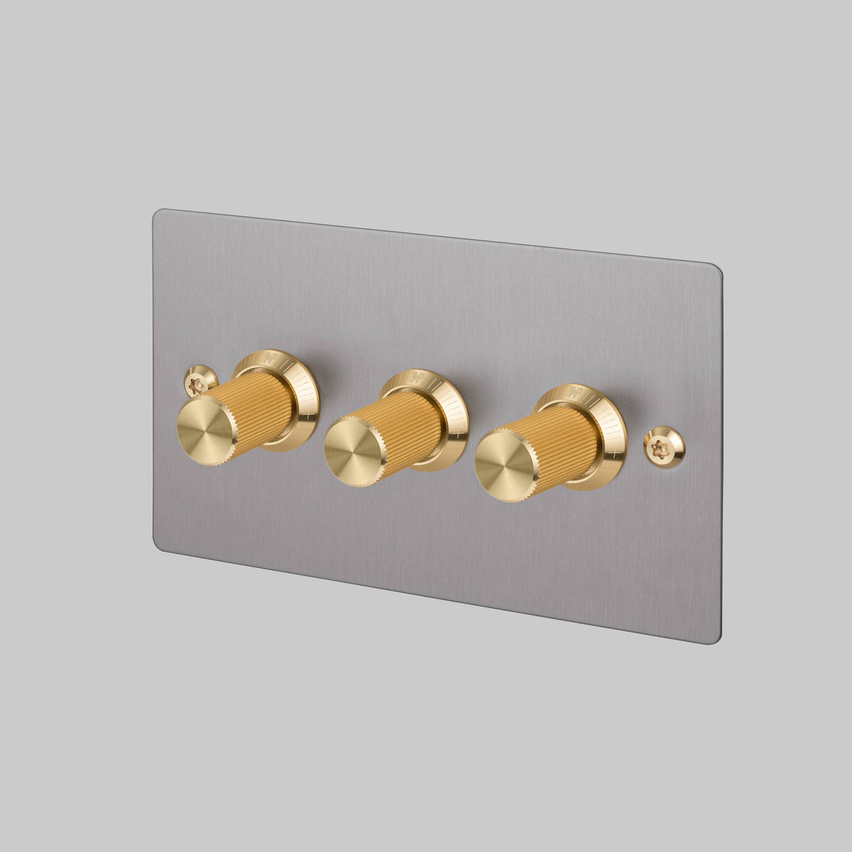 Buster + Punch 3G dimmer switch, Steel plate with Brass linear knurl knob, front angled view