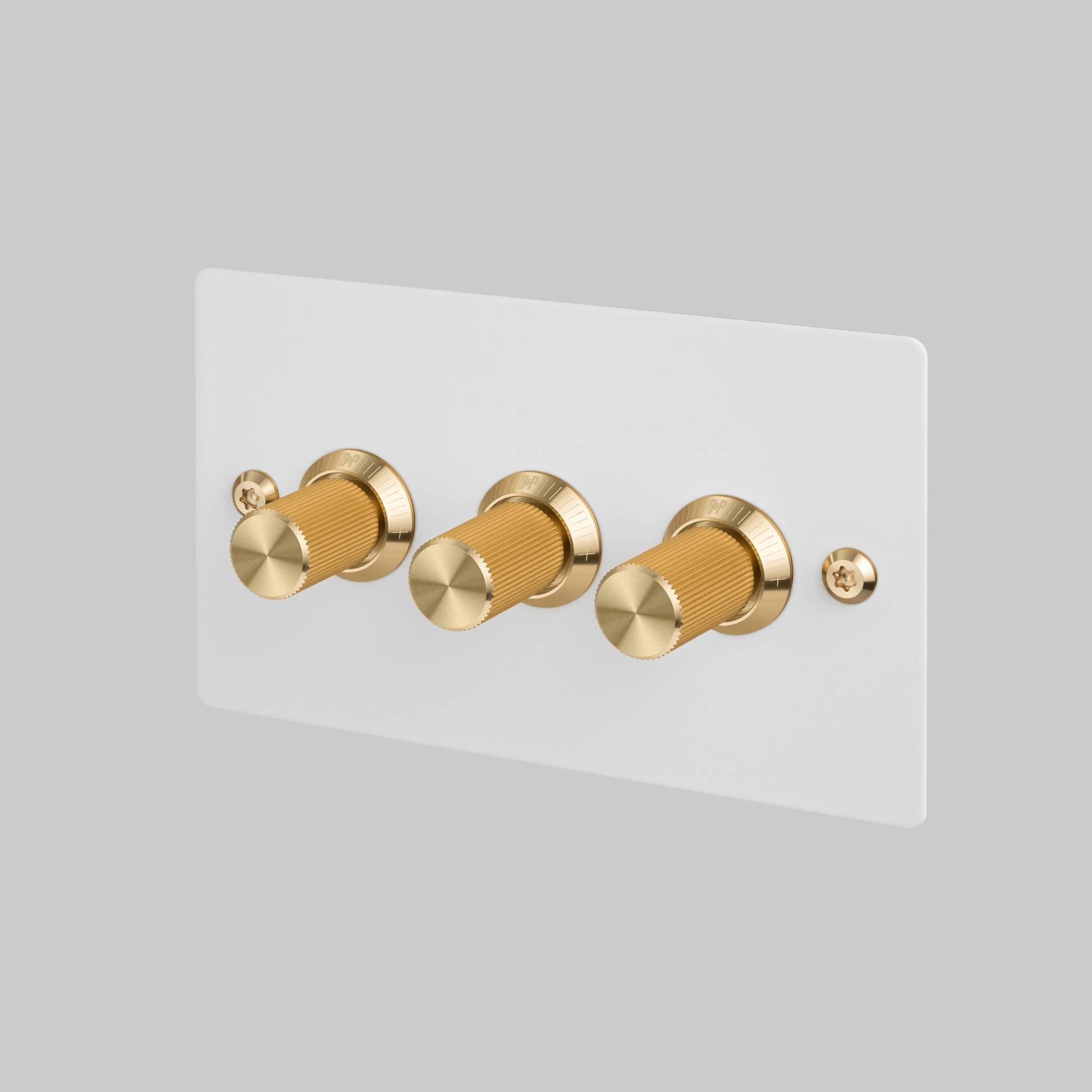 Buster + Punch 3G dimmer switch, White plate with Brass linear knurl knob, front angled view