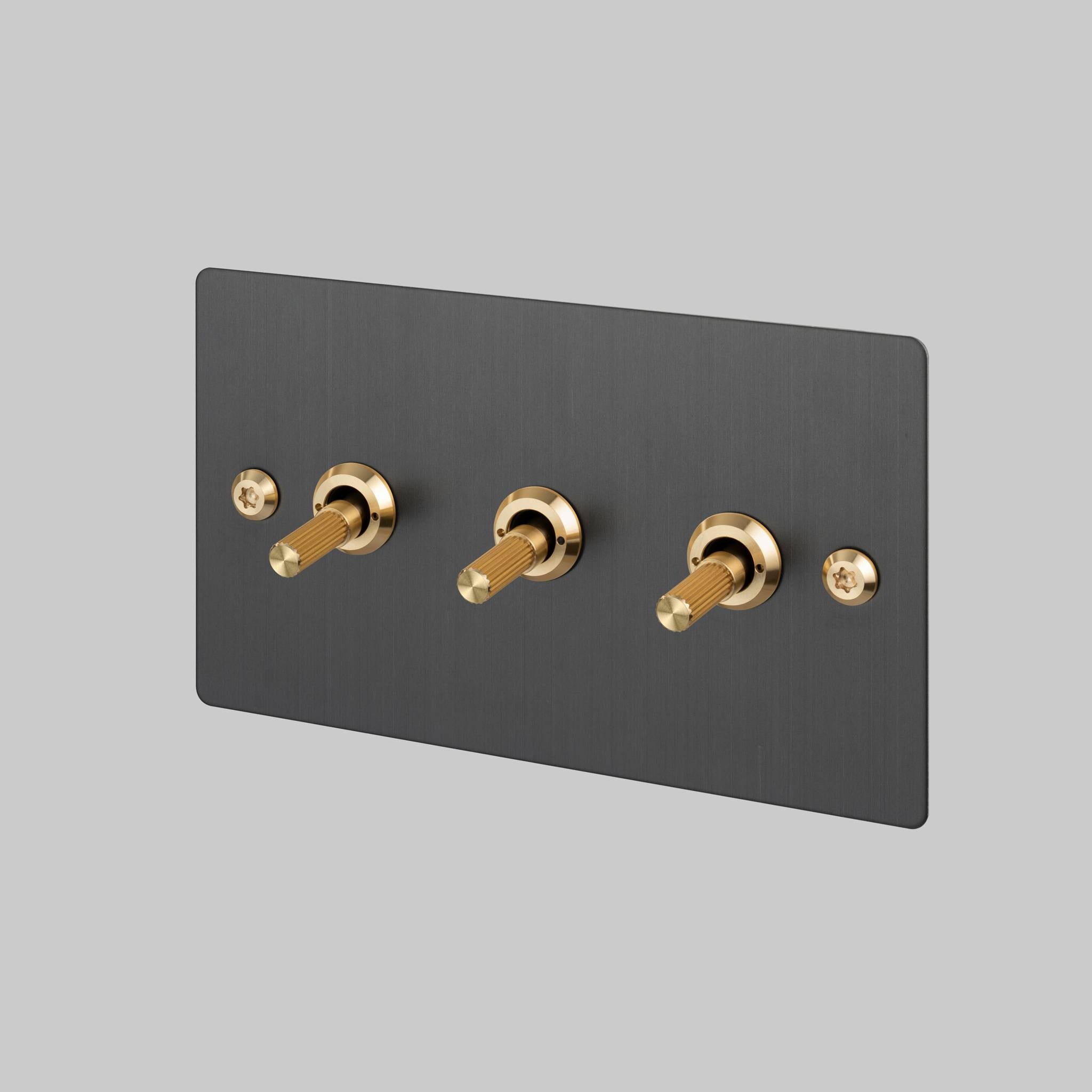 Buster + Punch 3G toggle switch, Smoked Bronze plate with Brass linear knurl toggle arm, front angled view