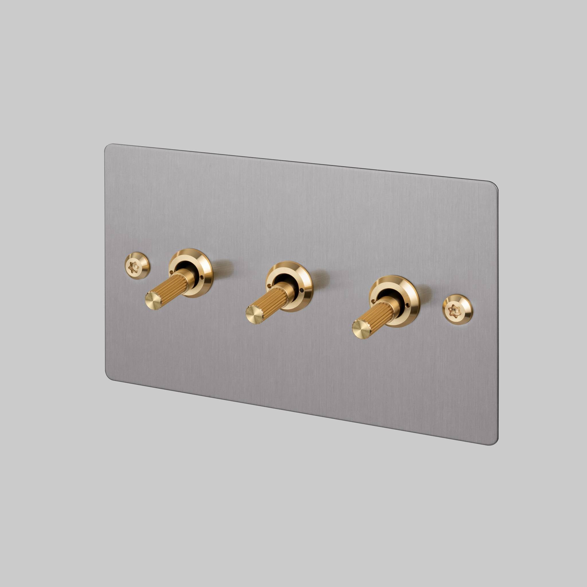 Buster + Punch 3G 2-way toggle switch, Steel plate with Brass linear knurl toggle arm, front view