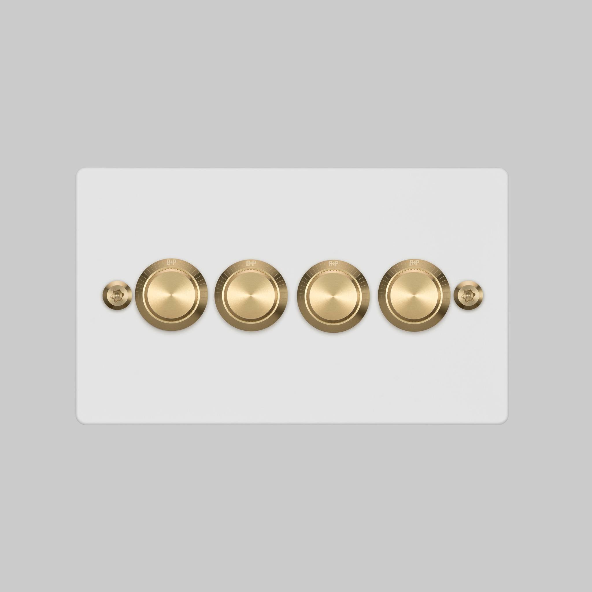 Buster + Punch 4G dimmer switch, white plate with brass linear knurl knobs, elevated angle view