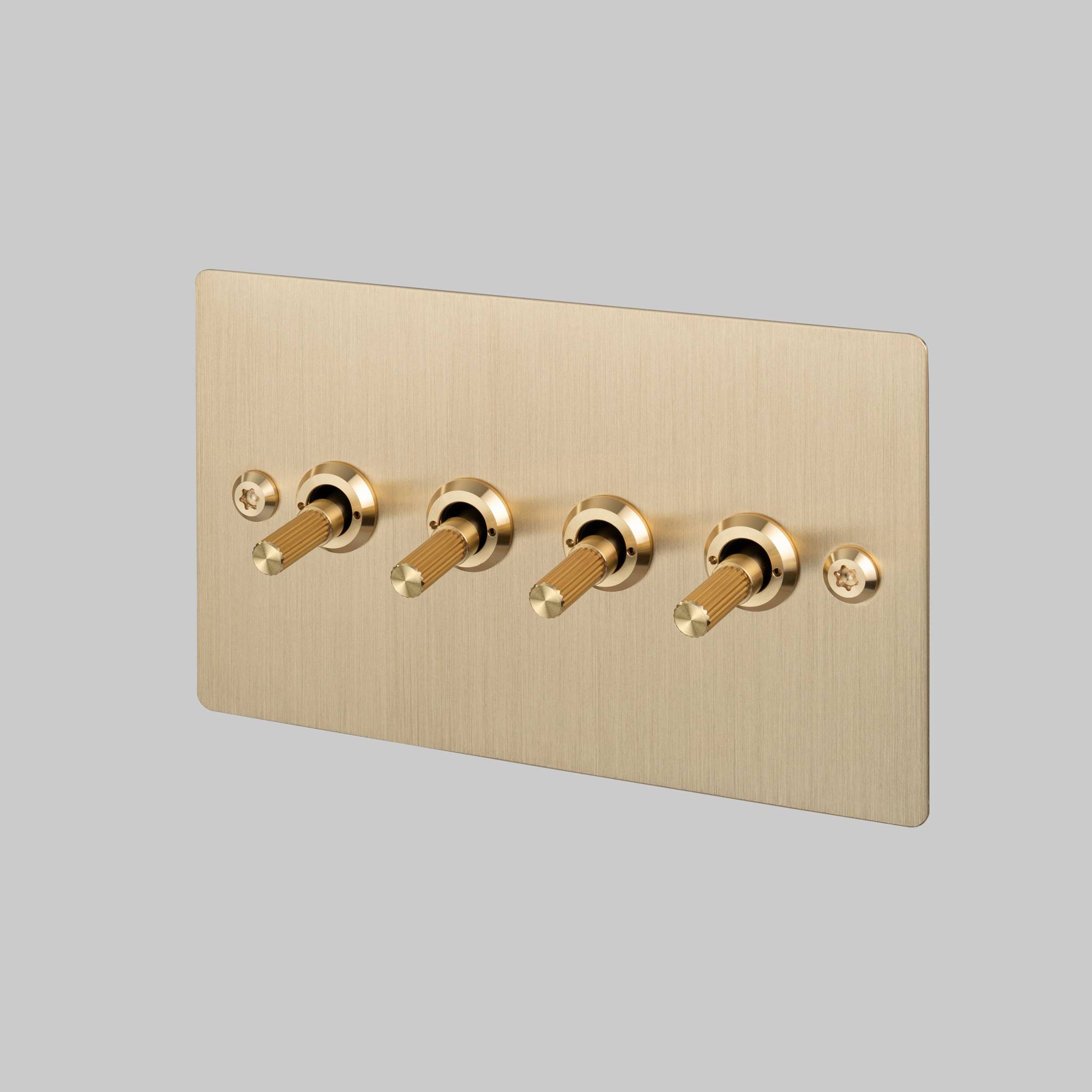 Buster + Punch 4G toggle switch, brass plate with brass linear knurl toggle arms, front view