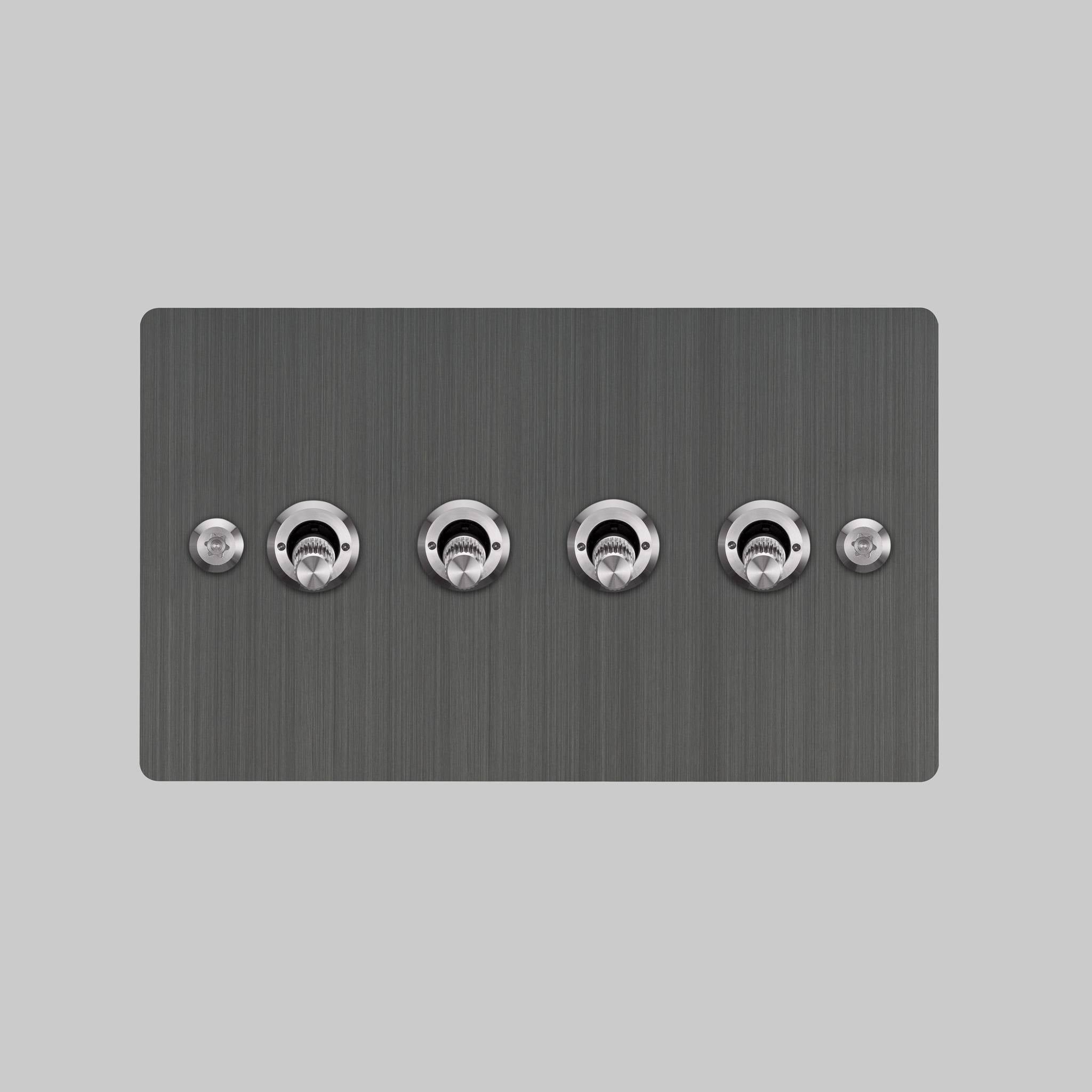 Buster + Punch 4G toggle switch, smoked bronze plate with steel linear knurl toggle arms, elevated angle view