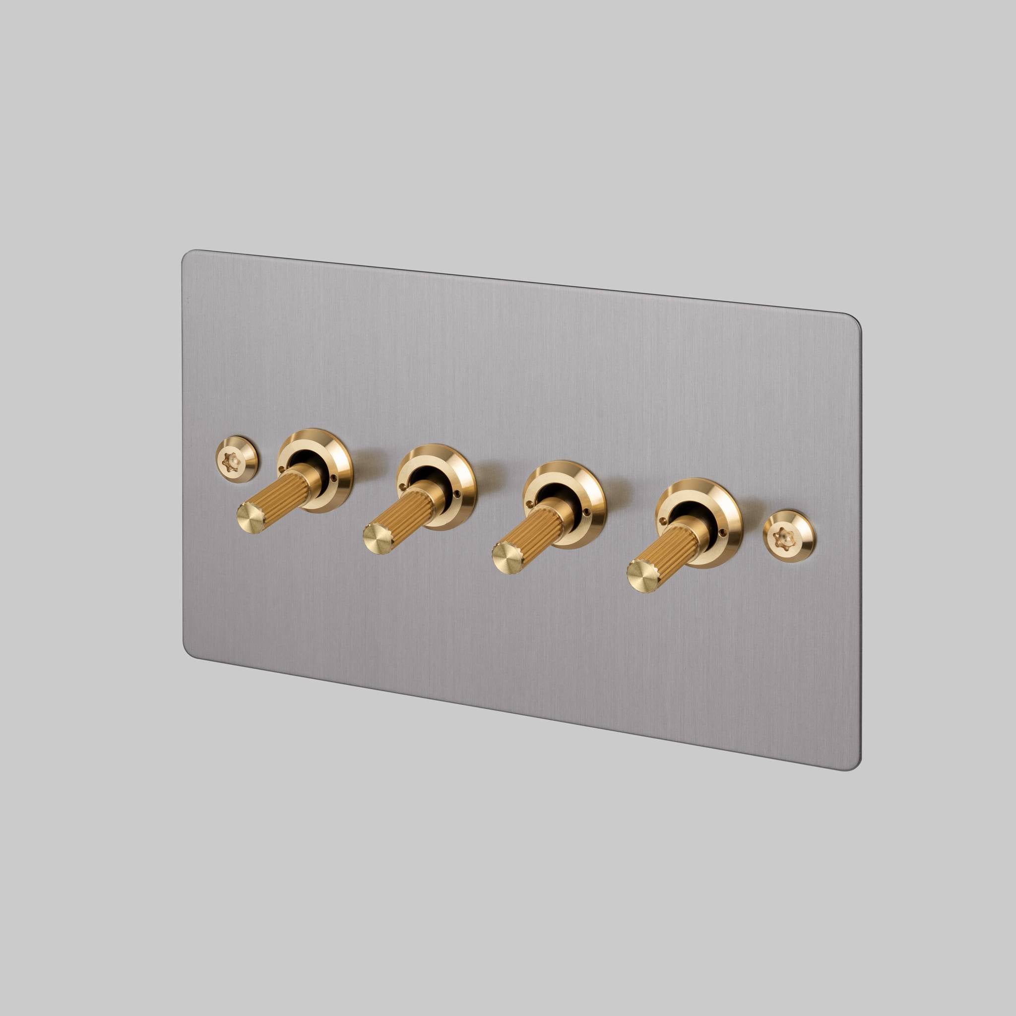 Buster + Punch 4G toggle switch, steel plate with brass linear knurl toggle arms, front view