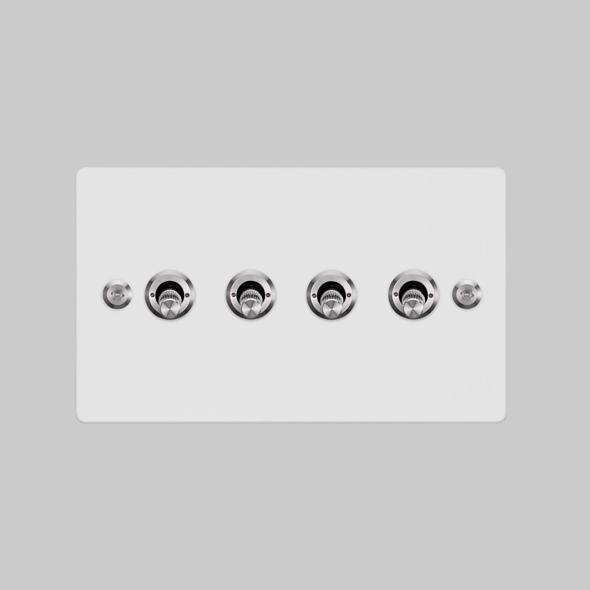 Buster + Punch 4G toggle switch, white plate with steel linear knurl toggle arms, elevated angle view
