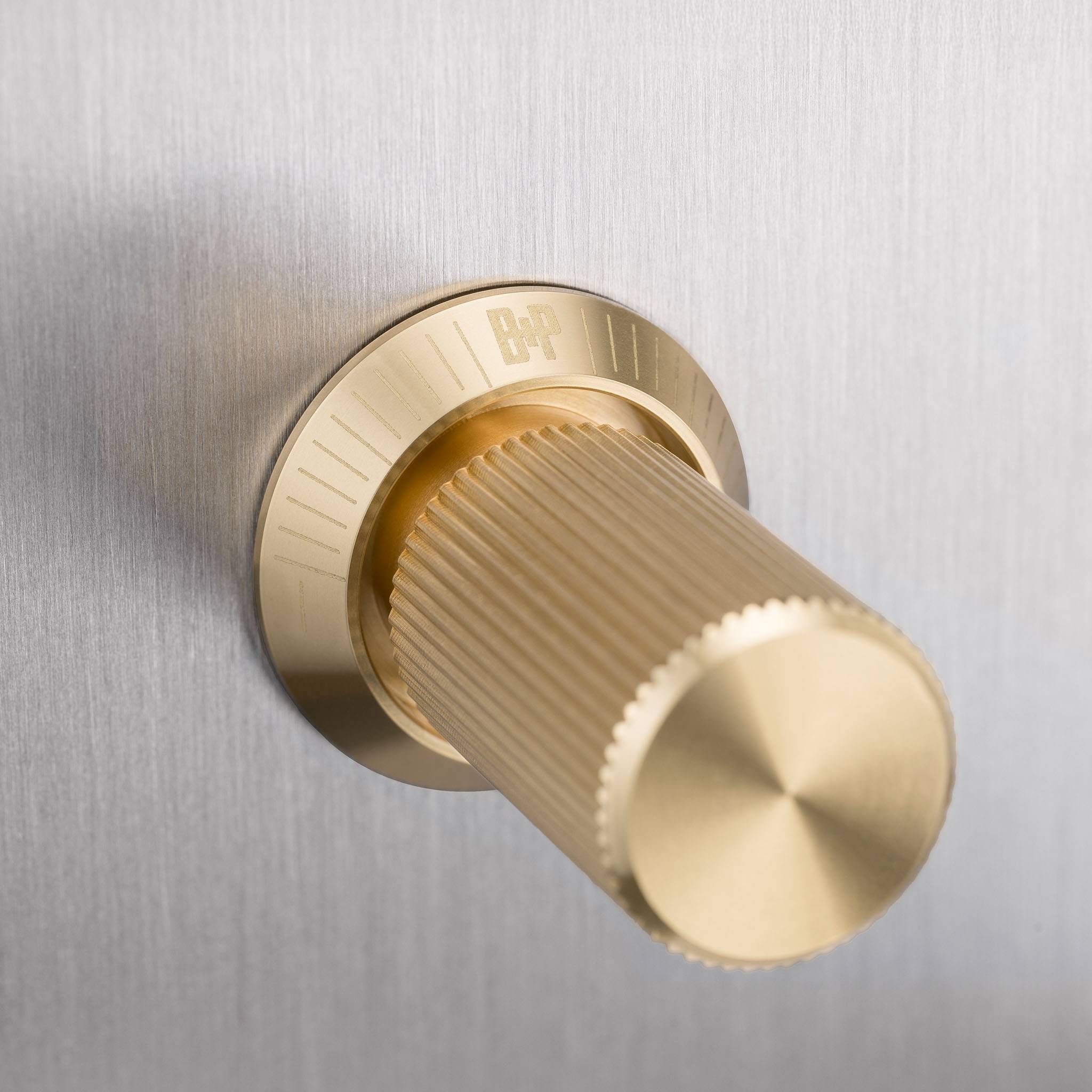 Buster + Punch 4G dimmer switch, Steel plate with Brass linear knurl dimmer knob, close up of the knurl detail