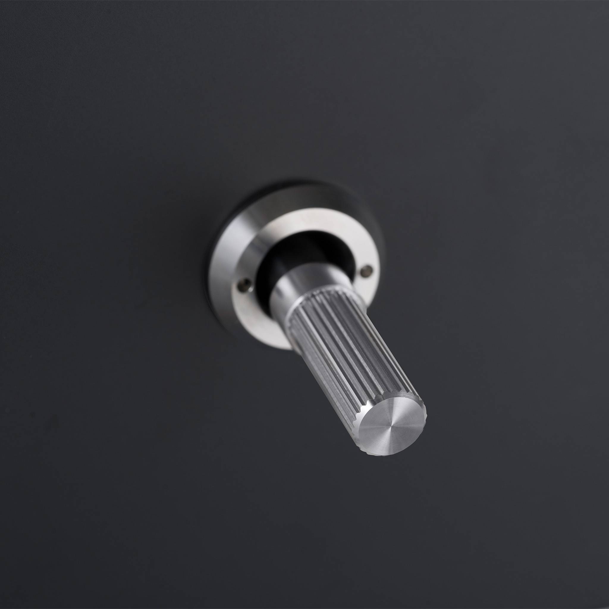 Buster + Punch 1G 2 way toggle switch, Black plate with Steel linear knurl toggle arm, close up of the knurl detail