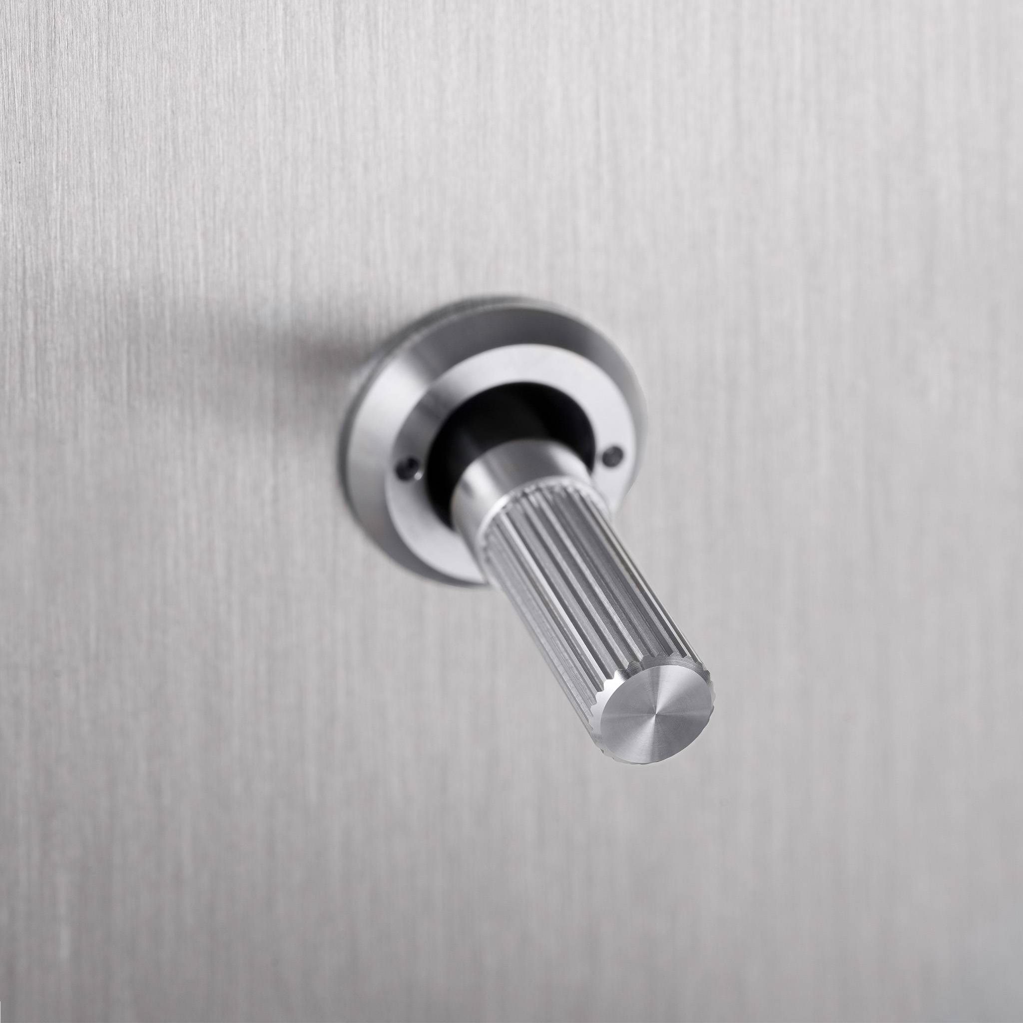 Buster + Punch 1G intermediate toggle switch, steel plate with steel linear knurl toggle arm, close up of the knurl detail