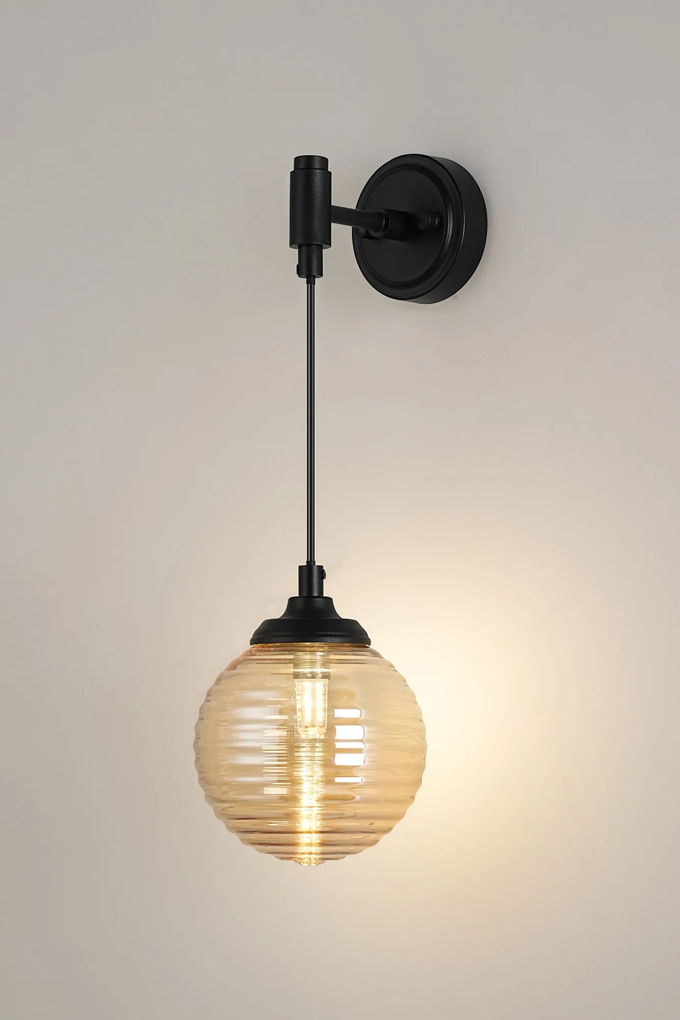 Dene Adjustable Single Wall Light IP44 - Satin Black & Amber Ribbed Round Glass