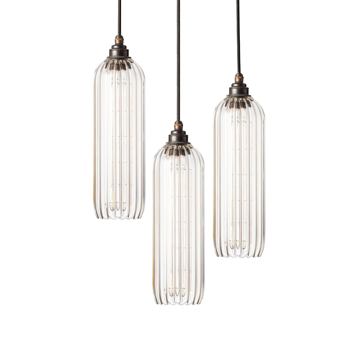 Leverint Bickley Cascade Cluster 3 Way with three tall clear ribbed glass pendants at staggered heights, dark bronze toned lamp holders and black fabric flex, studio shot on white