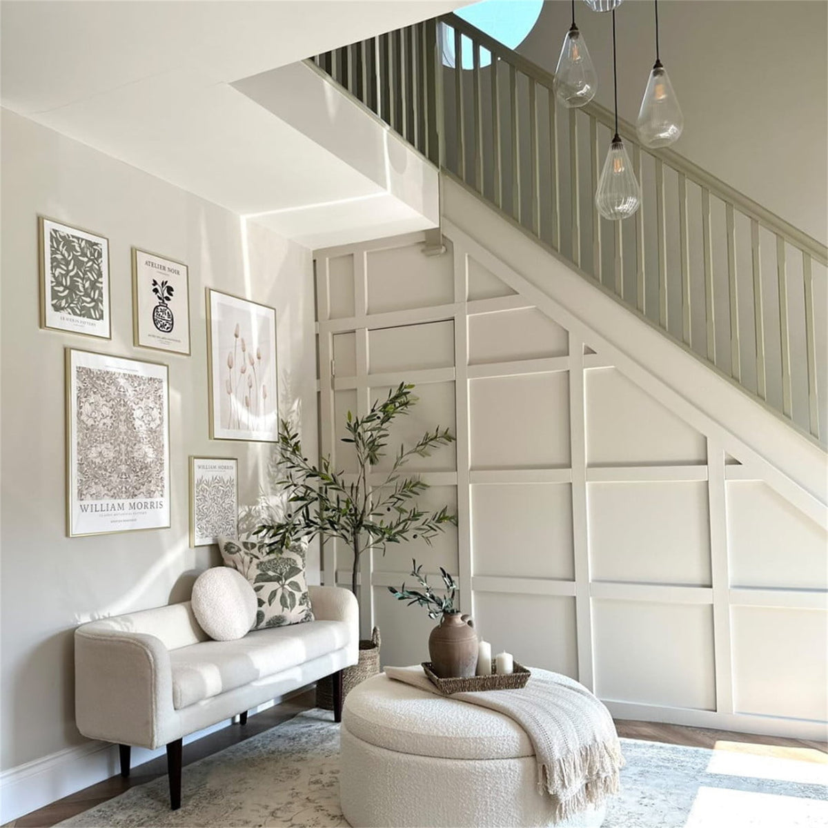 Several Leverint Kingston teardrop pendants in clear and ribbed glass hung at different heights beside a staircase