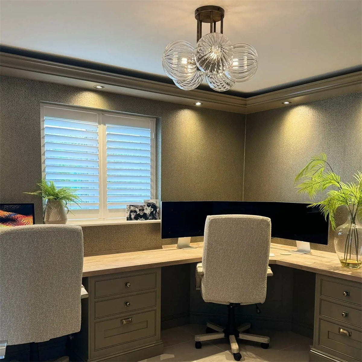 Leverint Pimlico Chandelier 5 Way, five clear ribbed glass globes on a brass toned ceiling plate, lit above a home office with a corner desk and two monitors
