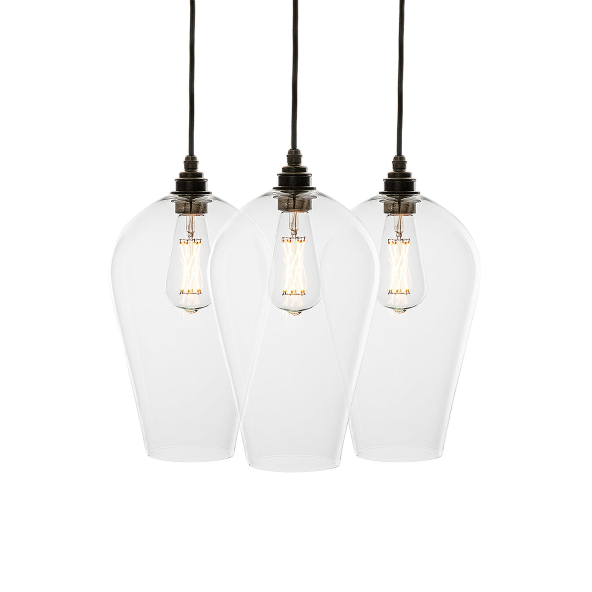 Leverint Waterloo Flush Cluster 3 Way, studio shot on white of three tall tapering clear glass pendants hanging in a row on black flex with dark metal lamp holders and filament bulbs