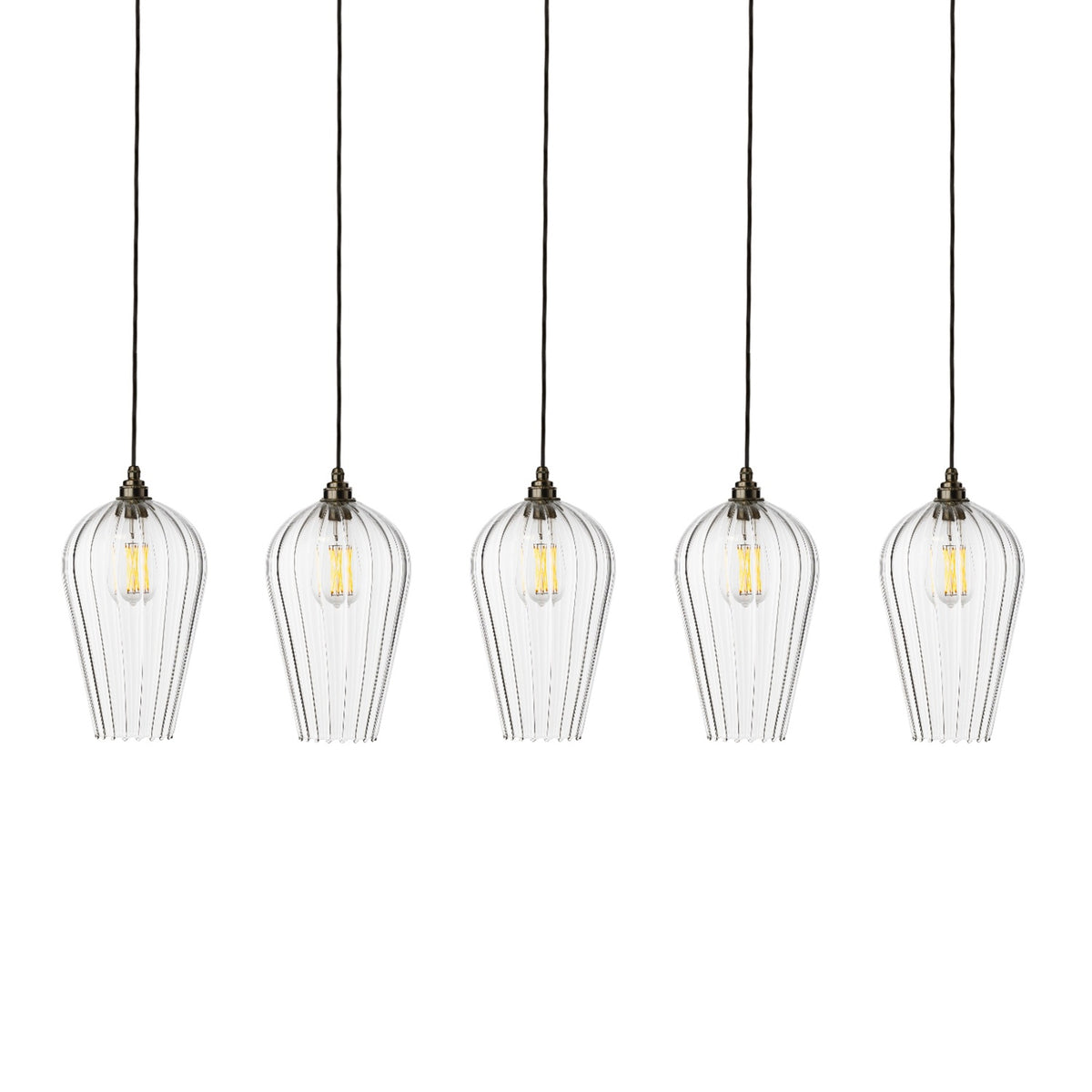 Leverint Waterloo Linear Flush Cluster 5 Way, five tall tapering ribbed clear glass pendants with filament bulbs on dark flex in a row, studio shot on white