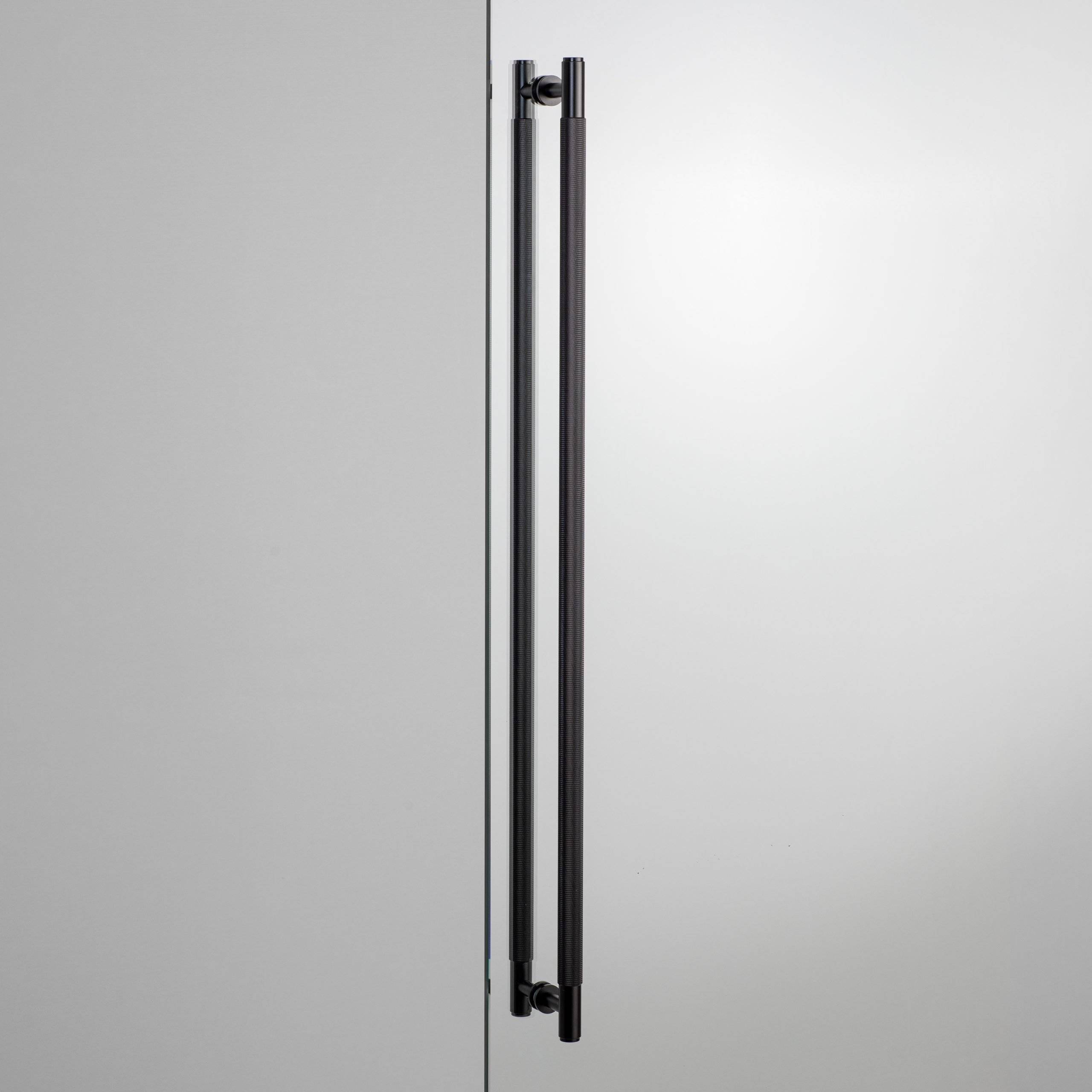 Buster + Punch Double Sided Closet Bar in Black Cross Knurl fitted through a glass door