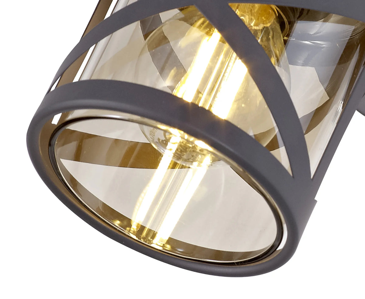 Close-up of the Fabula Leaden spotlight's crossed grey bands and cognac glass, with a lit filament bulb inside